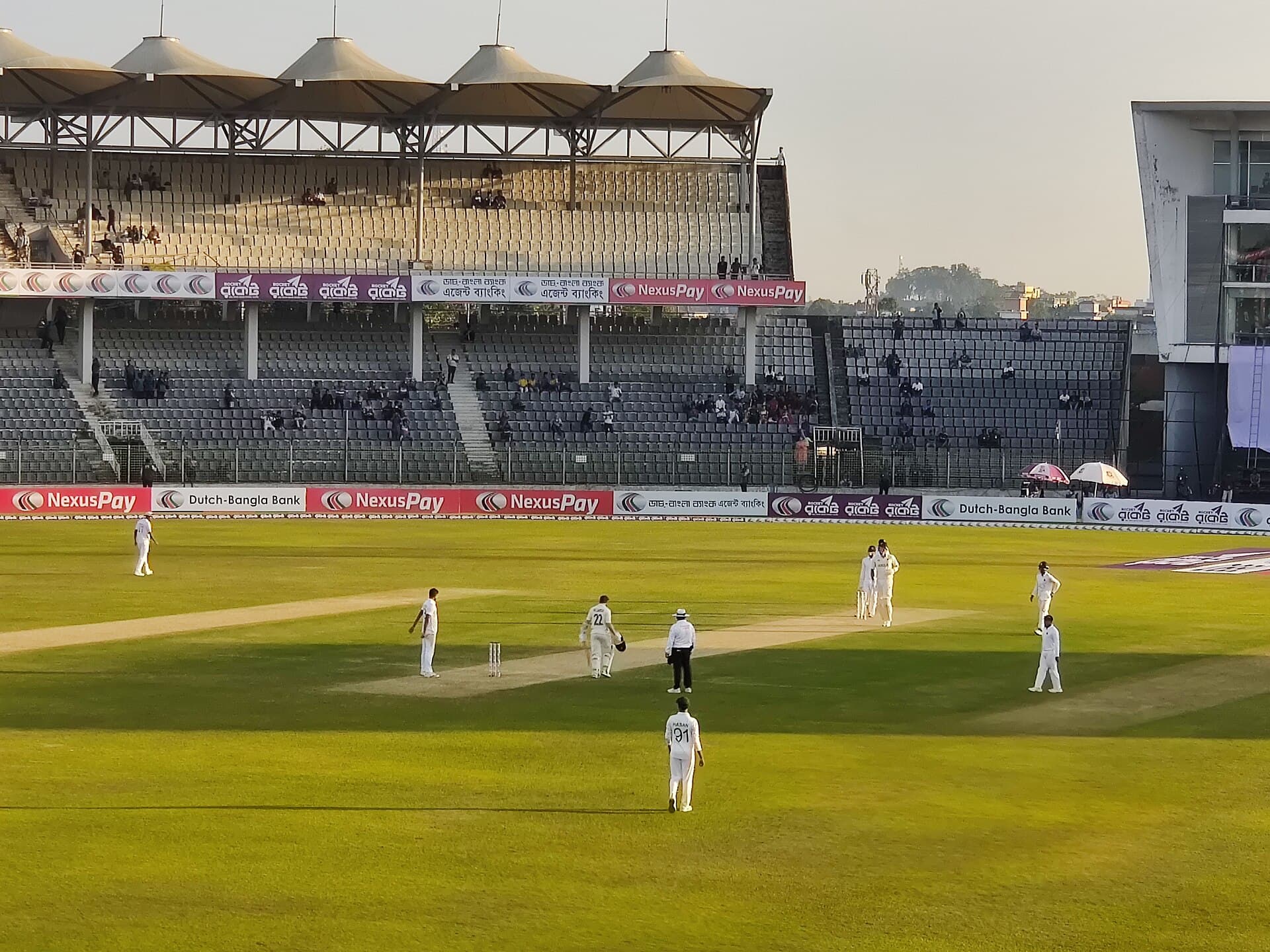 Fielders in whites around the batter during a Test match in Sylhet